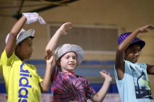 From left, Ernesto Vides-Austin, Lincoln Beasley, and Niles Brown dance to "YMCA" in a 1970 themed skit at the annual camp Pine Tree and Camp YOGO variety show supported by the Greenbelt Recreation Department at the Greenbelt Youth Center on Thursday.