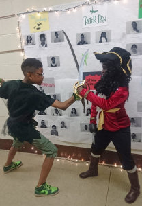 Maliq White (Peter Pan, Grade 6) sword fighting with Brianna Obeng-Agei (Hook, Grade 5)