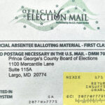 An envelope addressed to Prince George's County Board of Elections, with the stars-and-stripes "Official Election Mail" logo. The return address has been obscured. In the lower right corner of the envelope, a yellow label bears the printed message, "Return to Sender, Insufficient Address, Unable to Forward."